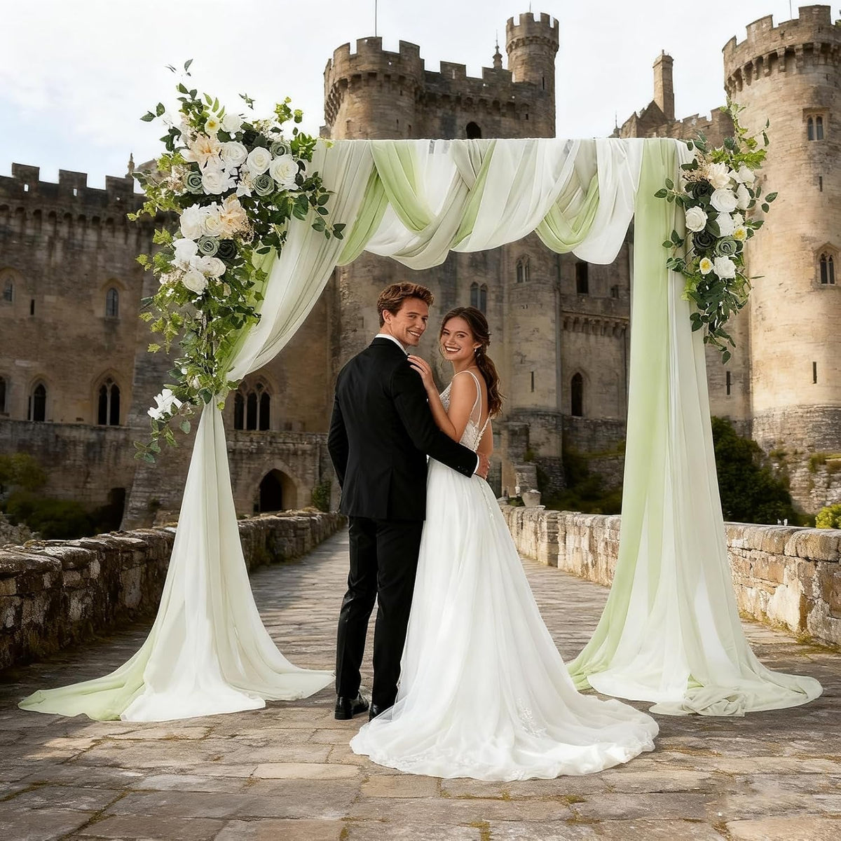 Green wedding arch flowers with chiffon drapes